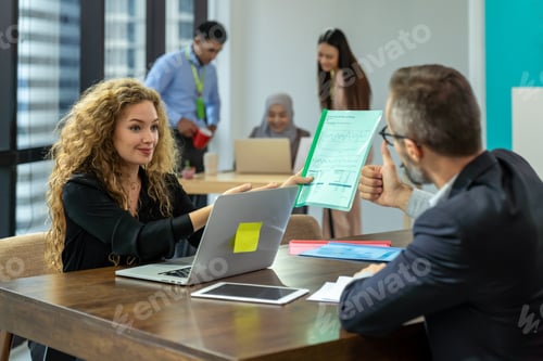 Preview: Businesswoman And Businessman Discussing Work, Sitting And Working With Computer Laptop In Office