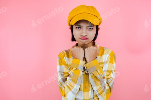 Preview: Asia Young Girl Wear Yellow Shirt And Yellow Hat With Pink Background.