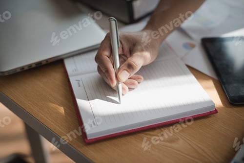 Preview: Hand Of Businessmen Holding Pen While Writing Notes In The Book During The Meeting.