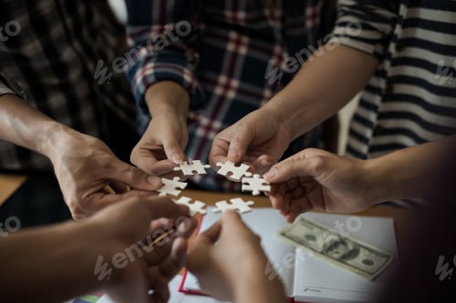 Preview: Hands Group Of Business People Assembling Jigsaw Puzzle White. Below Is The Graph Paper Business