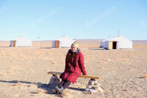Preview: Asia Tourist Woman Sit Down At Gobi Desert National Park At Mongolia.With Gobi Desert Background.