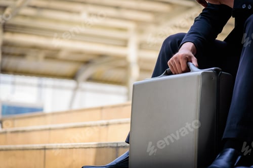 Preview: The Asian Businessman Has Holding A Black Bag.