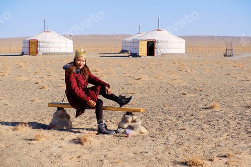 Preview: Asia Tourist Woman Sit Down At Gobi Desert National Park At Mongolia.With Gobi Desert Background.