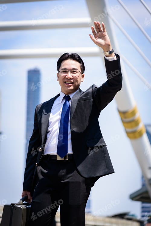 Preview: The Asian Businessman Has Holding A Black Bag And Making Hello Gesture.