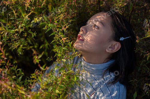 Preview: Portrait Young Asian Girl With Green Grass.