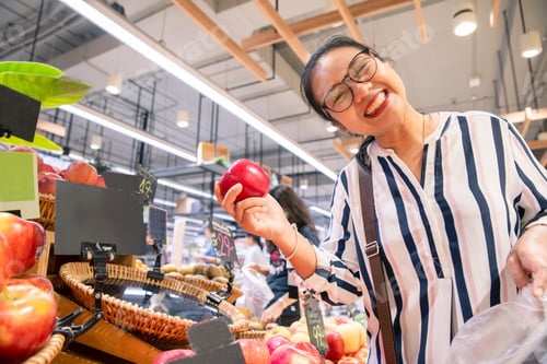 Preview: Happy Woman Buying Fresh Fruit In Convenience Store