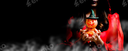Preview: Happy Halloween. Beautiful Woman Costume And Holding Pumpkin Toy. Copy Space On Black Background.