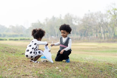 Preview: Happy African American Little Boy And Girl Holding Dustpan And Collecting Trash Into A Bag. Group
