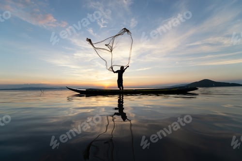 Preview: Asian Fishermen On Wooden Boat For Catching Freshwater Fish In Nature River At Before Sunset Is A