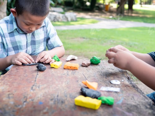 Preview: Cute Two Asian Are Playing Colorful Clay On Table In The Nature Park. Development Of Fine Motor