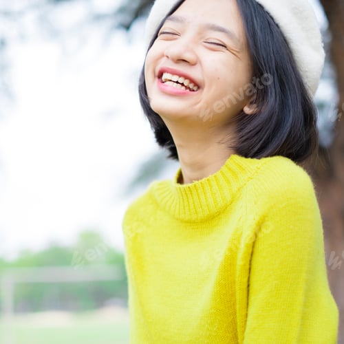Preview: Portrait Smile Young Girl Wear Yellow Sweater On Nature Background.