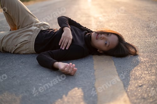 Preview: Portrait Beautiful Girl Lay Down On The Long Road, Looking Camera, Sunset Time.