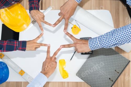 Preview: Businessman And Engineer Connecting Their Hands To Star Shape. Top View. Industry Business And