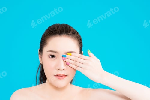 Preview: Beauty Young Asian Woman Portrait Isolated On Blue Background Touching Face. Half Naked Attractive