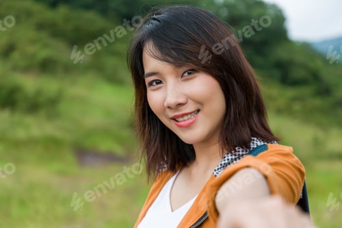 Preview: Close Up Of Smiling Asian Young Woman Hiker Hiking With Backpack Walking In Field Along Mountain