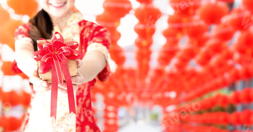 Preview: Happy Chinese New Year. Asian Woman Holding Gift Box. Copy Space And Red Lanterns Blur Background