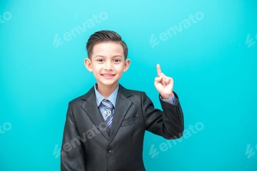 Preview: Young Boy In Business Suit Isolated In Blue. Handsome Early Teenage Boy Portrait Wearing Business