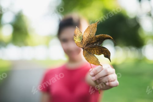 Preview: Cute Girl Holding The Leaf On Green Background