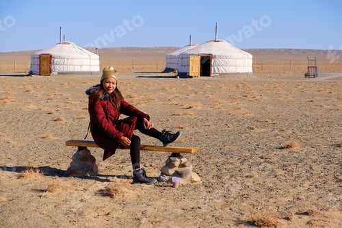 Preview: Asia Tourist Woman Sit Down At Gobi Desert National Park At Mongolia.With Gobi Desert Background.