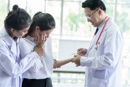 Preview: Health Professional Administering Injection to Young Woman Patient