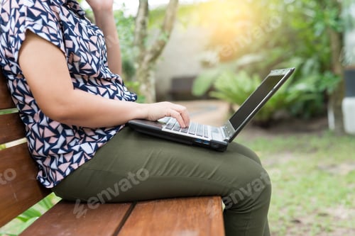 Preview: Close Up Pretty Young Woman Browsing The Internet On Her Laptop At Outdoor