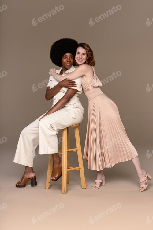 Preview: Studio Shot Of An African American Woman In Her 20'S And A Caucasian Woman In Her 20'S Embracing