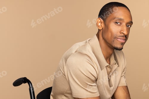 Preview: Portrait Of African American Man In His 40S Sitting In A Wheelchair Disabled Person On Neutral