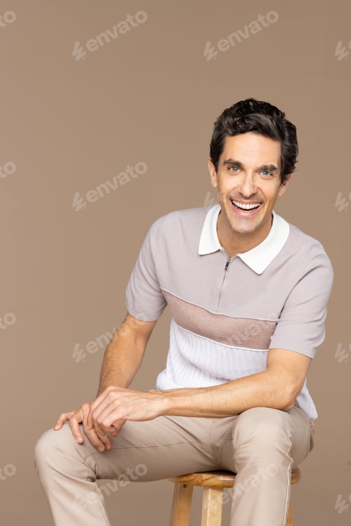 Preview: Studio Shot Of A Beautiful Latino Man In His 40'S Laughing On A Neutral Background.