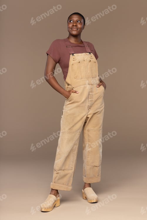 Preview: Three Quarter Length Portrait Of A Non-Binary Afro-Latino In Their 20S Smiling With Hands In
