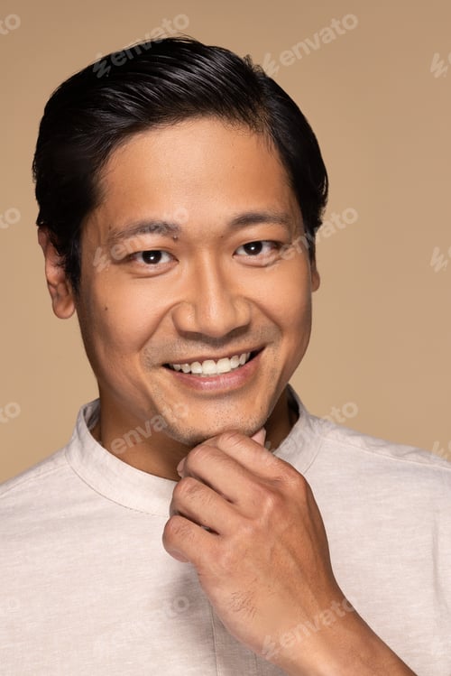 Preview: Portrait Of Handsome Chinese Man In His 30S Smiling And Posing Confidently On Neutral Background
