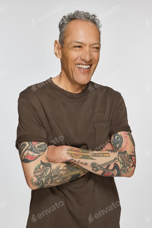 Preview: Portrait Of A Handsome Multiracial Man In His 50'S Smiling On A White Seamless.