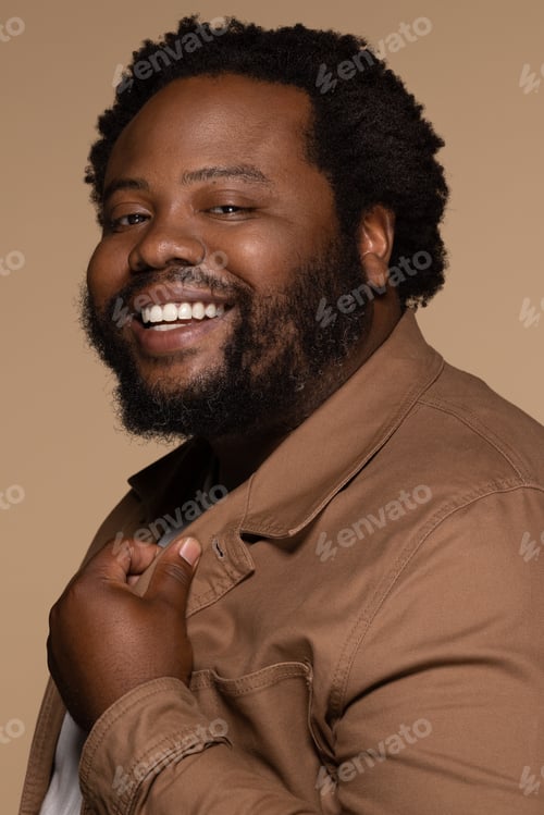 Preview: Portrait Of African American Man In His 30S Smiling Confidently And Posing On Neutral Background