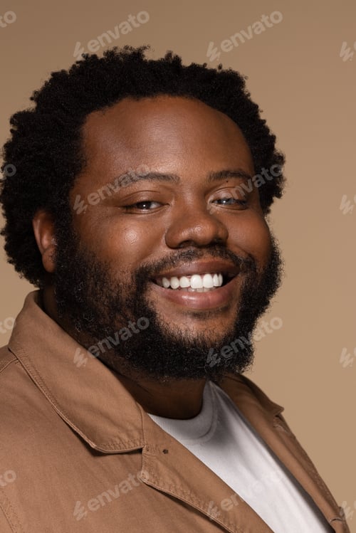 Preview: Portrait Of African American Man In His 30S Smiling Confidently And Posing On Neutral Background