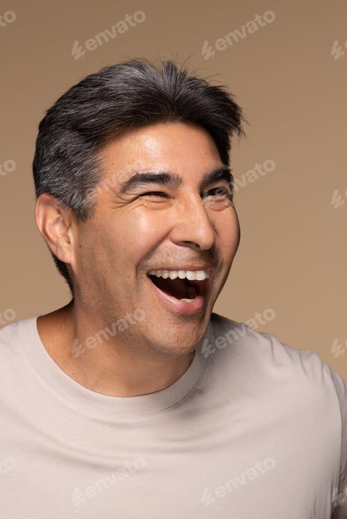 Preview: Portrait Of Multi-Racial Man In His 50S Smiling And Posing On Neutral Background