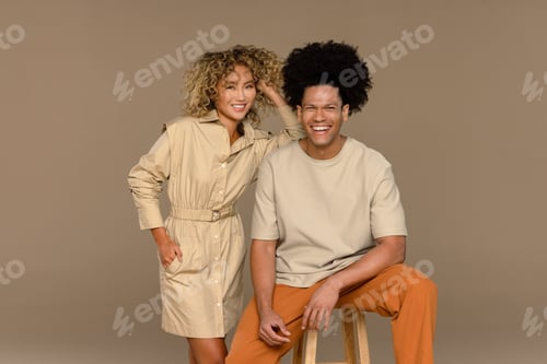 Preview: Studio Shot Of A Biracial Man In His 30'S And A Multiracial Woman In Her 20'S Smiling Together On A
