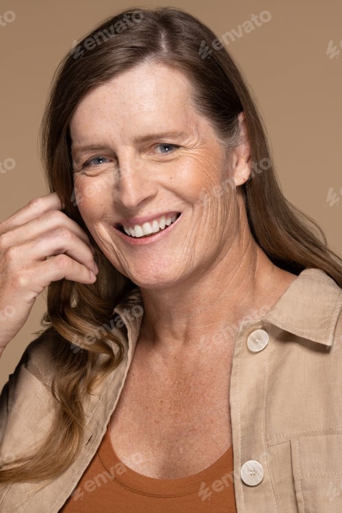 Preview: Portrait Of A Caucasian Transgender Woman In Her 50'S Smiling On A Neutral Background.