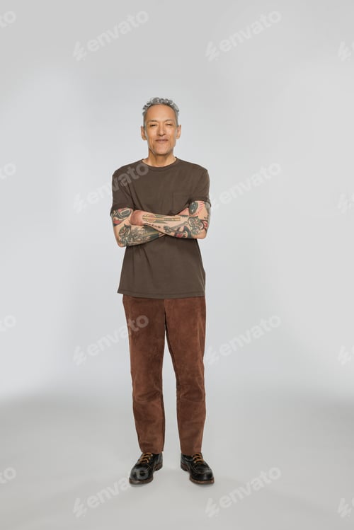 Preview: Full Length Shot Of A Gorgeous Multiracial Man In His 50'S Standing Confidently On A White Seamless.
