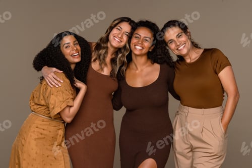 Preview: Four Smiling Women Posing Together in Studio