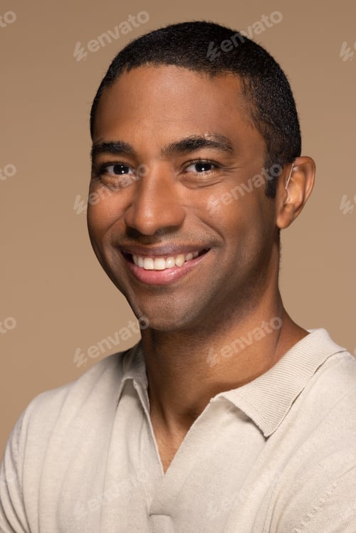 Preview: Close-Up Headshot Of Attractive Black Man In His 40S Posing Casually And Smiling On Neutral