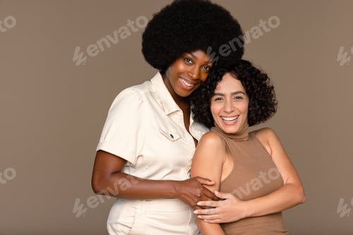Preview: Studio Portrait Of An African American Woman In Her 20S, And A Middle Eastern Woman In Her 30S On A