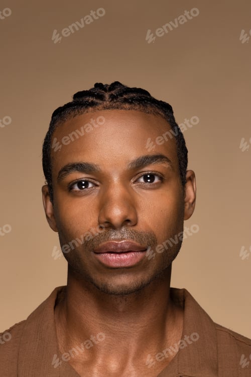 Preview: Close Up Portrait Of Attractive Young Black Man In His 20S Posing With Confidence On Neutral