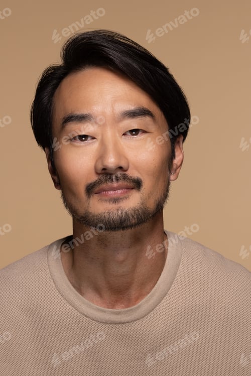 Preview: Portrait Of Beautiful East Asian Man In His 40S Posing On Neutral Background