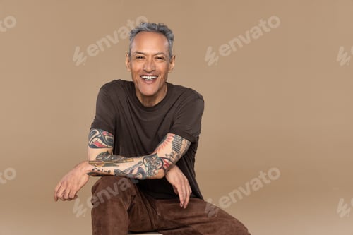 Preview: Studio Shot Of A Gorgeous Multiracial Man In His 50'S Smiling On A Neutral Background.