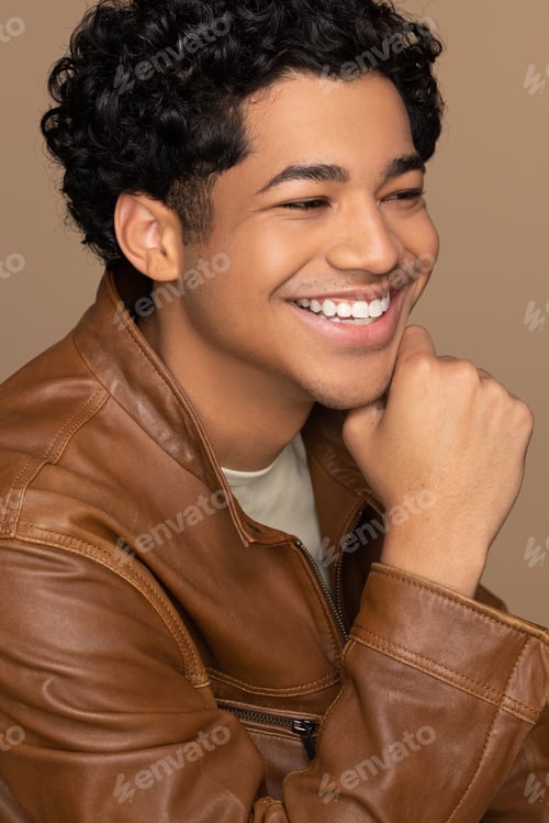 Preview: Profile Of A Beautiful Multiracial Man In His 20'S Smiling On A Neutral Background.