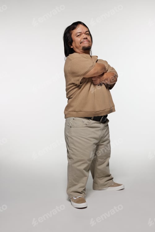 Preview: Full Length Shot Of Hispanic Man In His 50S With Dwarfism Smiling And Posing With Arms Crossed On