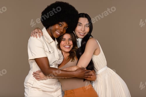 Preview: Three Quarter Length Studio Portrait Of Three Models Of Diverse Ethnicities Posing Smiling On A