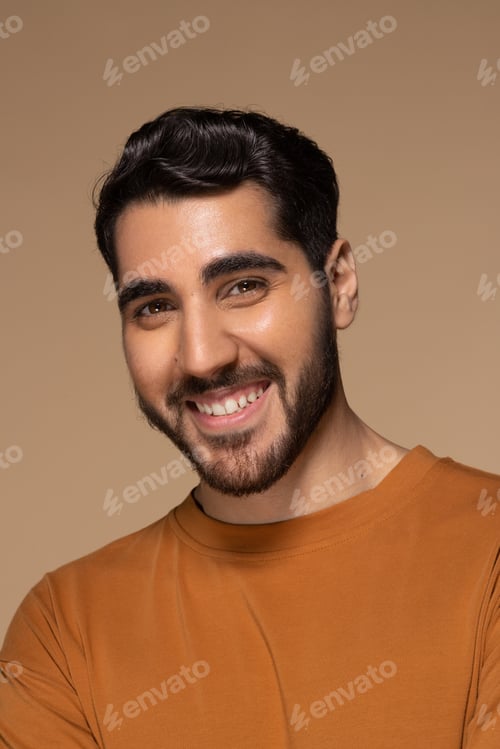 Preview: Studio Portrait Of Young Attractive Middle Eastern Man In His 20S Smiling Happy On Neutral