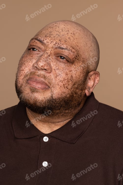 Preview: Portrait Of A Gorgeous Multiracial Man In His 50'S Looking To The Side On A Neutral Background.