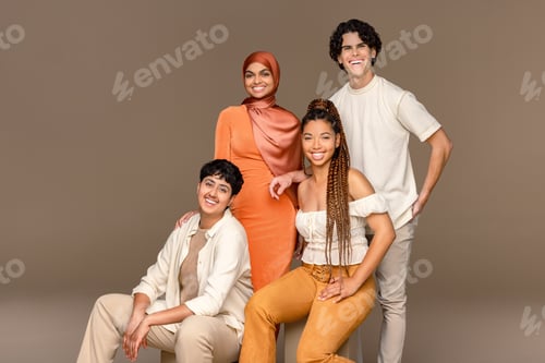 Preview: Full Length Studio Portrait Of Four People From Diverse Ethnic Backgrounds Posed Smiling On A