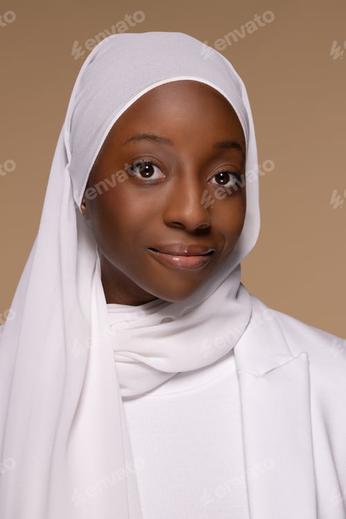 Preview: Portrait Of Gorgeous Black Woman In Her 20S Wearing White Hijab And Posing With Confidence On